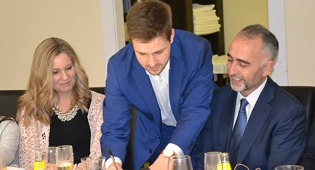 Paul Henry doing close-up magic on a cocktail corporate event